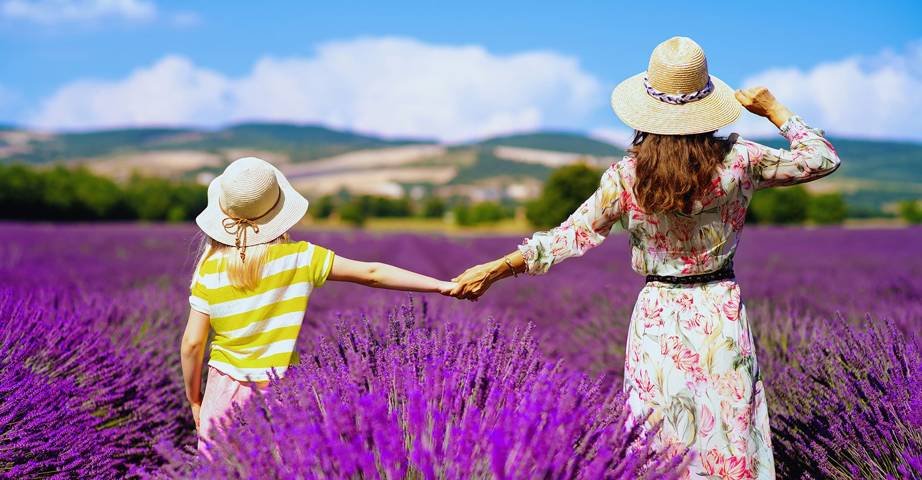 a litte girld and a woman into lavender fields